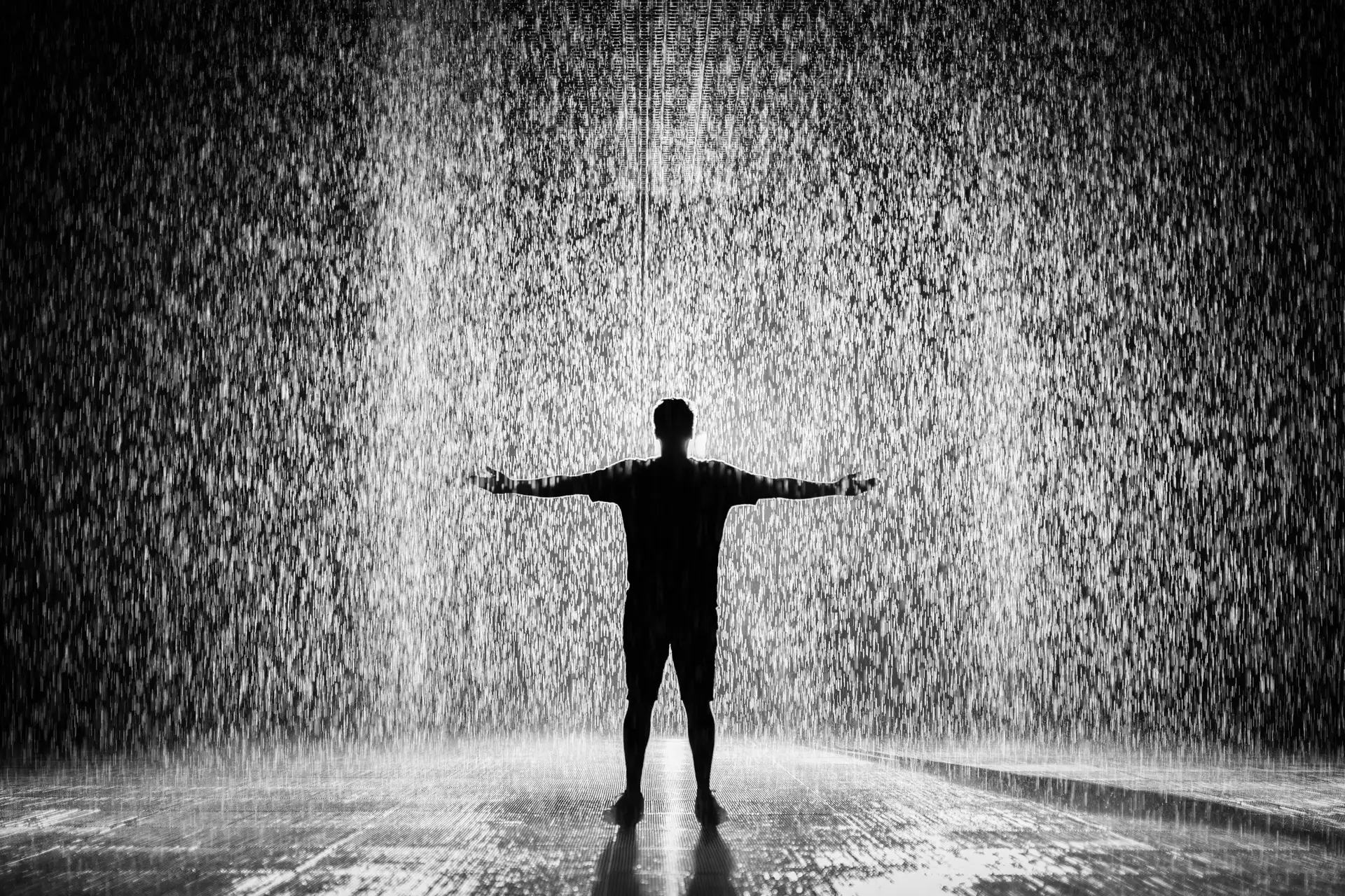 Silhouette and Grayscale Photography of Man Standing Under the Rain