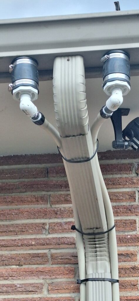 two deviators placed in the gutter near the downspout