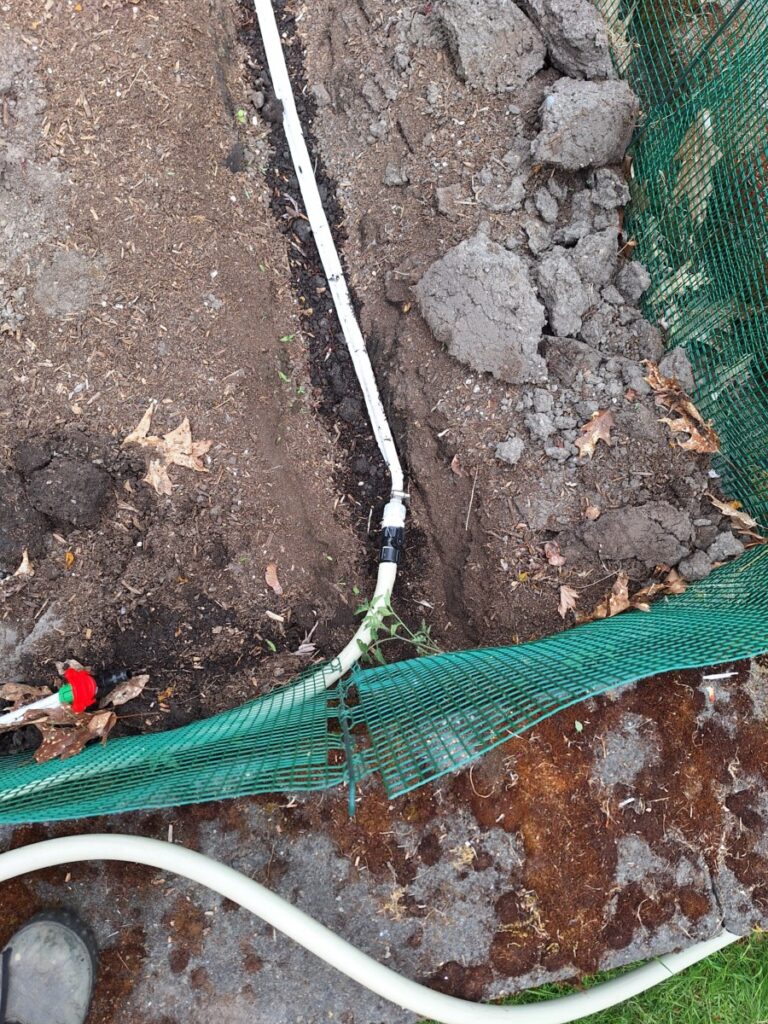 pressure gage displaying one to two psi connected to an rdi drip tape irrigation system