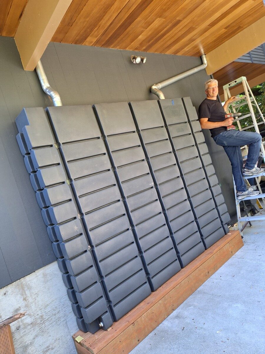 Proud graduate installing a rainwater harvesting tank in Seattle on July nineteenth.