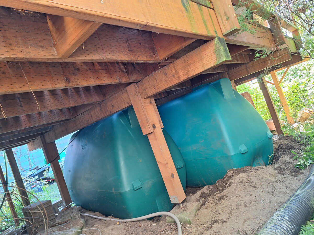 Back view of two bottom filling rain tanks