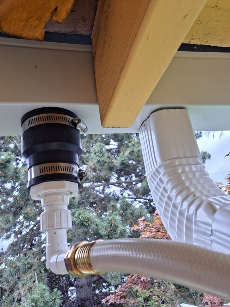 Close‑up of Product Water Deviator gutter insert with hose connection attached to the gutter face.