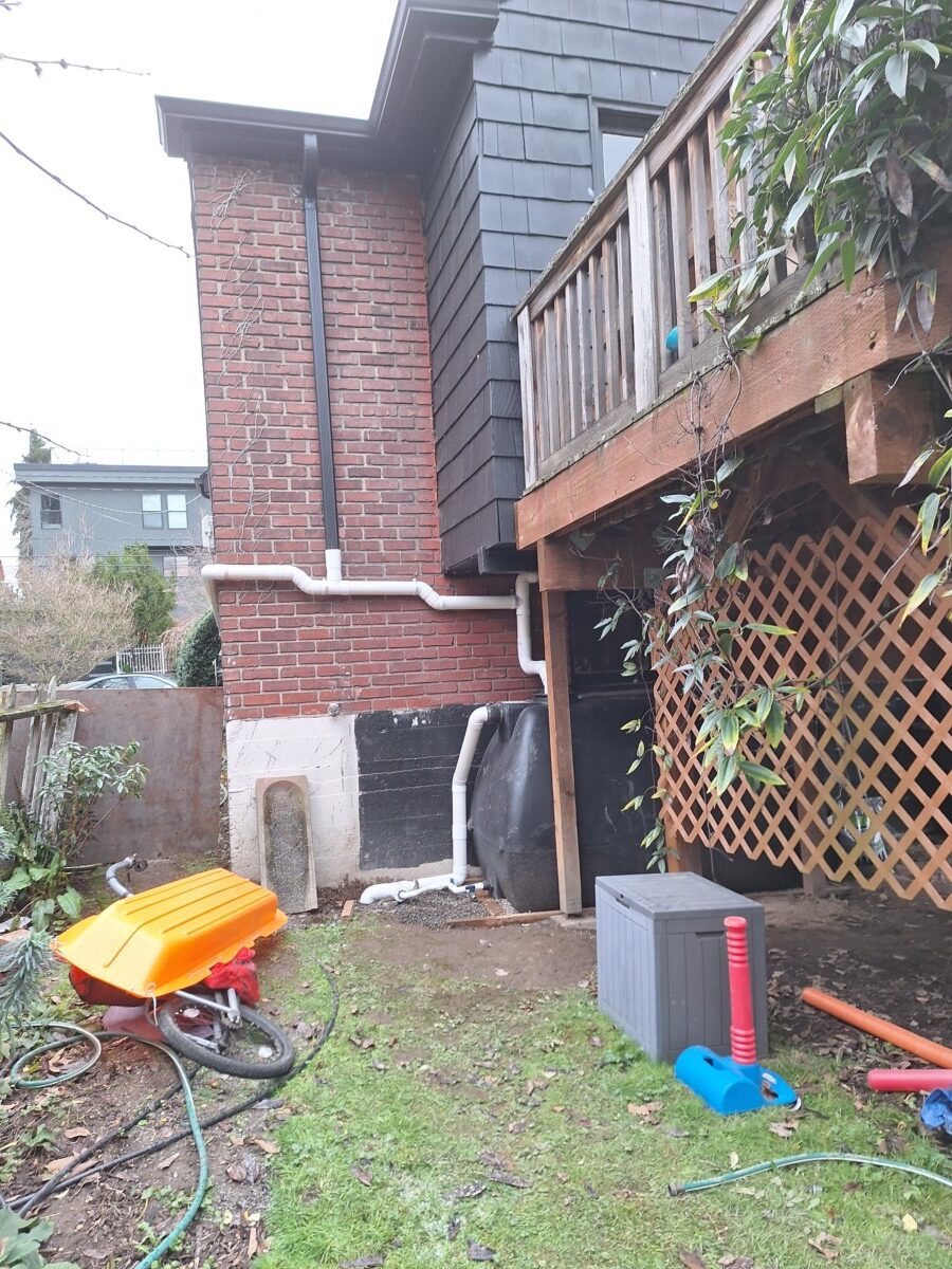 Horizontal rainwater cistern installed under a deck in Seattle