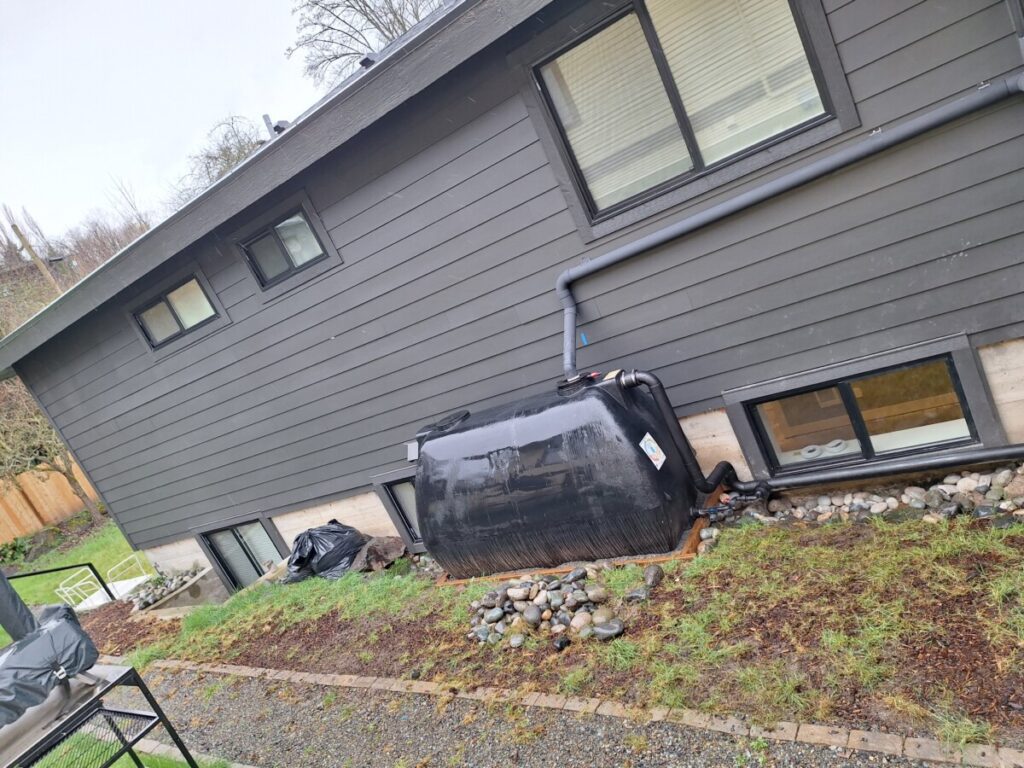 Seattle rainwater harvesting tanks installed at a RainWise home collecting roof rainfall