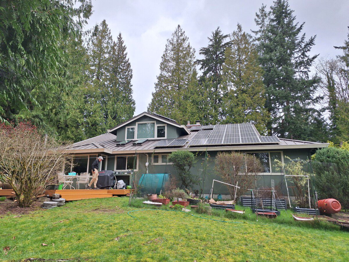 Downspout diverter feeding rainwater storage tank