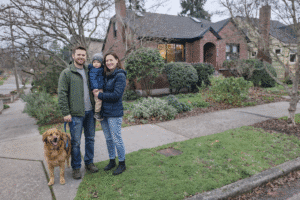 Family walking outside on a cool rainy day in Seattle near a home with a garden, representing rainwater collection and RainWise system benefits